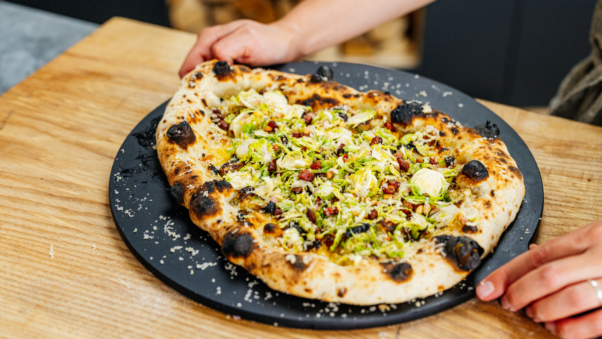 Brussels Sprouts Pizza on pizza server recipe poster image