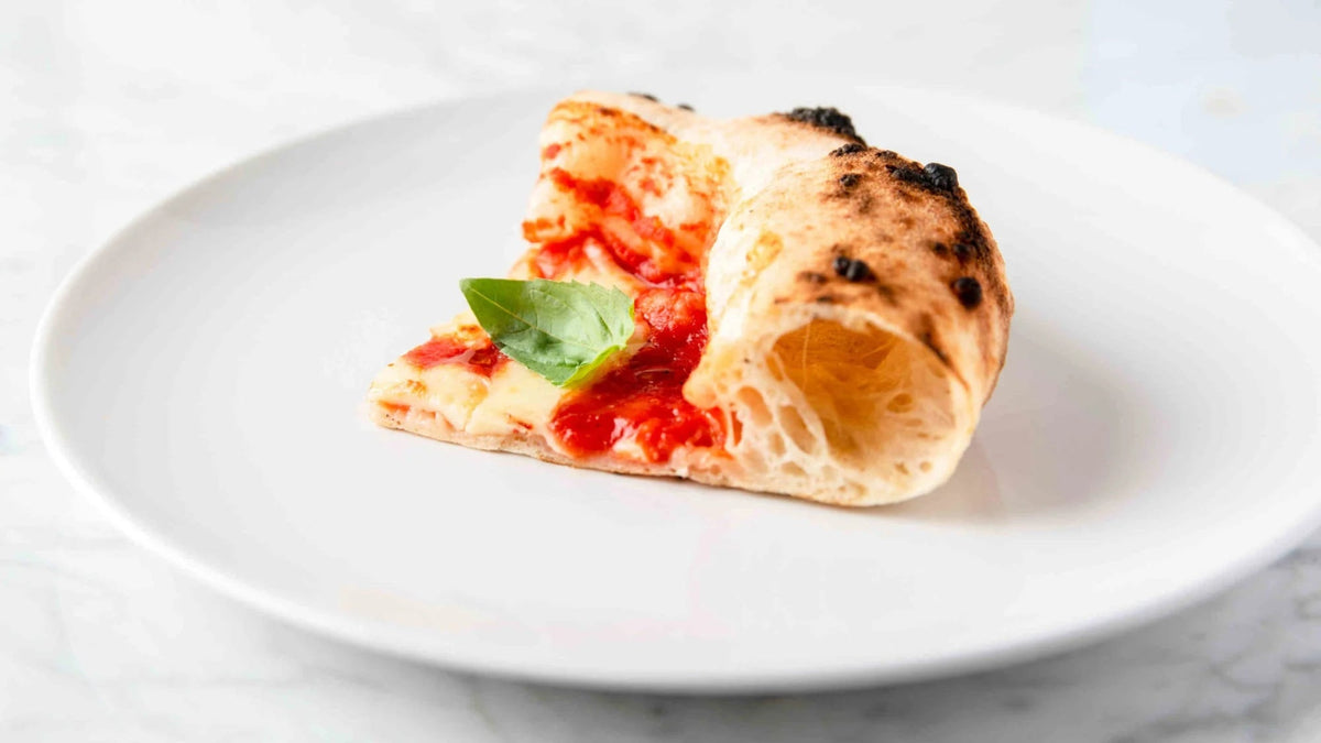 A slice of Canotto Style Neapolitan pizza on a plate recipe poster image