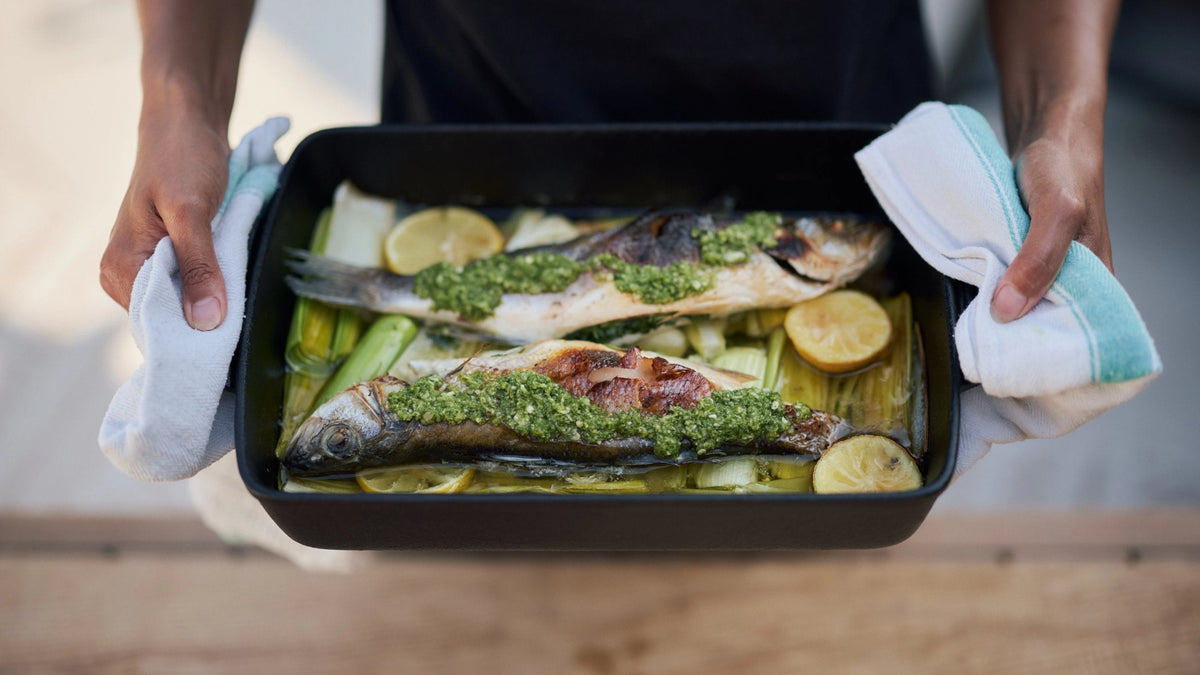 Two Baked Sea Bass with Thai Green Chilli Sauce in a dish