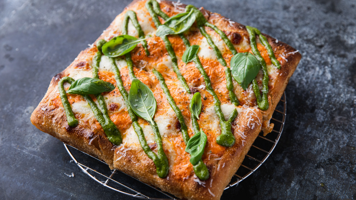 Sicilian Pizza topped with basil and pesto recipe poster image